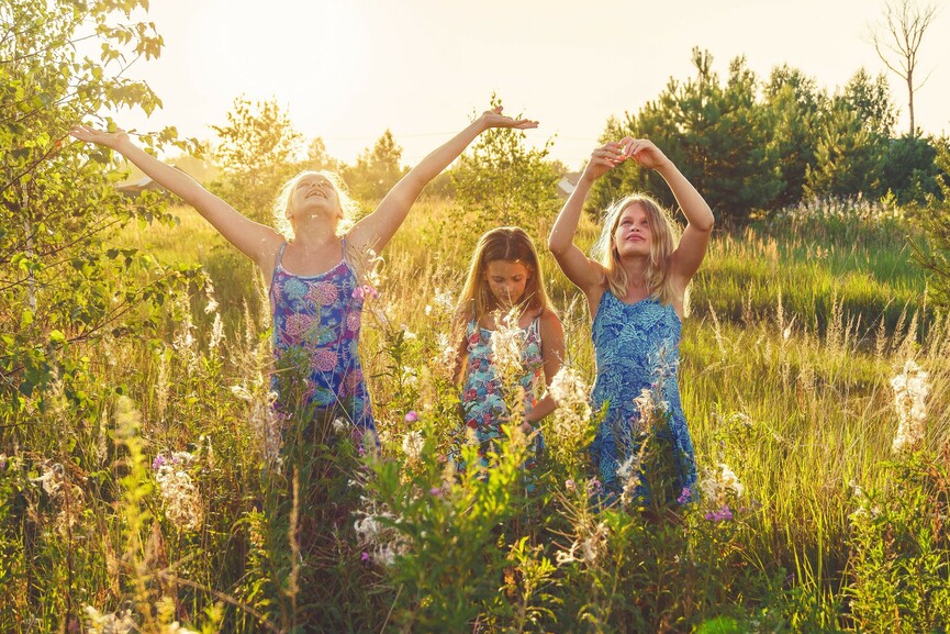 Three girls in field during summer