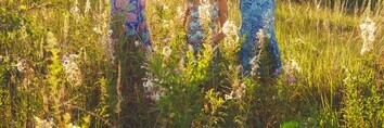 Three girls in field during summer